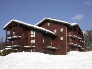 a large brown building with snow on it at Appartement Les Carroz d'Arâches, 2 pièces, 4 personnes - FR-1-572-87 in Arâches-la-Frasse