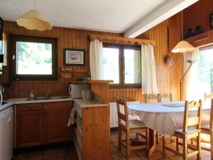 a kitchen with a table and a table and chairs at Appartement Les Carroz d'Arâches, 4 pièces, 8 personnes - FR-1-572-127 in Arâches-la-Frasse