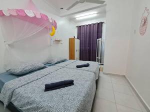 a bedroom with two beds with black handles at Private Water Park at Cozy House HS Sweet Homestay in Cukai +16 photos