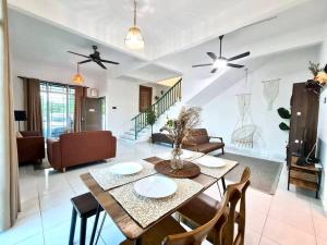a dining room and living room with a table and chairs at Private Water Park at Cozy House HS Sweet Homestay in Cukai