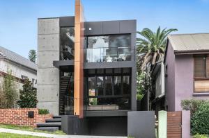 a contemporary house with a black facade at The Arc Bondi Beach in Sydney