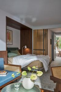 a bedroom with a large bed and a living room at M Village Tú Xương in Ho Chi Minh City