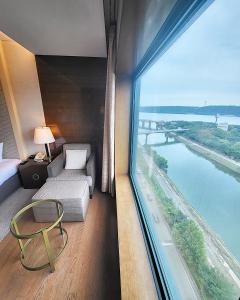 a bedroom with a large window with a view of a river at Niagara Hotel in Seoul