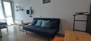 a living room with a blue couch and a table at Appartment in Bakuriani in Bakuriani