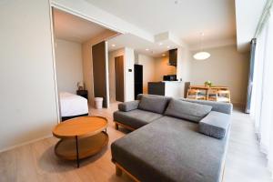 a living room with a couch and a table at Branchera Naha 1008 in Naha