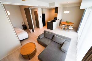 a living room with a couch and a table at Branchera Naha 1008 in Naha +76 photos