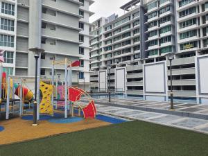 a playground in front of some tall buildings at Cozy Comfy Designer Home Mount Austin JB 5 Pax in Johor Bahru