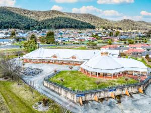 an aerial view of a building with a town in the background at Bowen Inn Motel in Lithgow