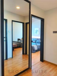 a mirror in a room with a bed and a bedroom at Brojat Suite Family Sea View @ Imperium Residence in Kuantan