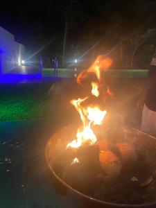 a fire pit in a yard at night at Lena Resort in Beruwala