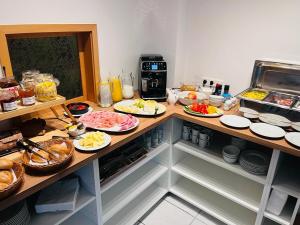 a kitchen with many plates of food on a counter at ApartOne Land-Hotel in Sebnitz