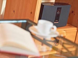 a close up of a table with a book and a speaker at Haus Gode Tied - Apt. 01 in Ostseebad Sellin