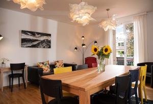 a dining room with a wooden table and chairs at Boutique Villa J87 in Interlaken