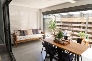 a living room with a table and a couch at Palm Beach the best trending place on the Coast in Gold Coast