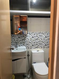 uma casa de banho com um WC, um lavatório e um espelho. em Condo in Ermita Manila, Near US Embassy, Mall and Parks with Excellent View em Manila