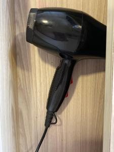 a black hair dryer sitting on a wooden table at 9293 Taman Sri idaman in Ayer Itam