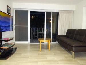 a living room with a couch and a coffee table at Waikiki 2BR King Beds Short Walk to Convention and Beaches in Honolulu