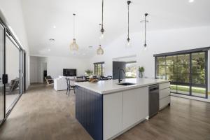 an open kitchen and living room with white walls at Koala Lane in Bonville