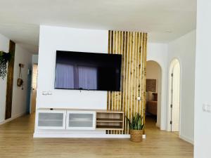 a living room with a flat screen tv on a wall at Luxury Sunset Ocean View in Arguineguín
