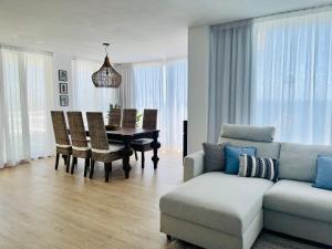 a living room with a couch and a table at Luxury Sunset Ocean View in Arguineguín