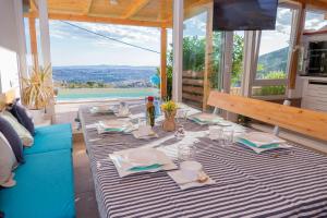 a dining room with a table and a blue couch at Barefoot Summer House in Klis +29 photos