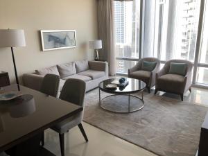 a living room with a couch and chairs and a table at Address fountain views apartments in Dubai