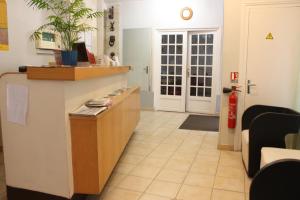 a lobby with a reception desk and a fire hydrant at Hotel Excelsior in Paris