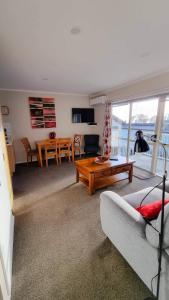 a living room with a couch and a table at Paihia Apartments in Paihia