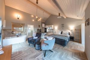 a bedroom with a bed and a tub in a room at Luxus Loft am Müritzufer in Sietow Dorf