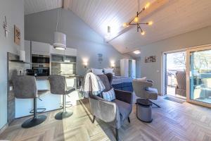 a kitchen and living room with chairs and a table at Luxus Loft am Müritzufer in Sietow Dorf