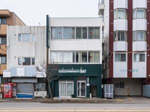 an apartment building on the corner of a street at Super conveniently located The GUEST HOUSE HAKODATE BAY in Hakodate +35 photos