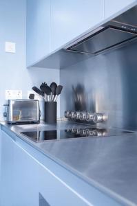 a kitchen with a counter top with a toaster oven at Lovely 1-bedroom flat in Chelsea in London