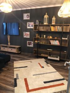 a living room with a rug on the floor at Cityscape Comfort with key lockbox in Sfântu-Gheorghe
