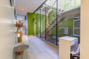 a room with a staircase and green walls at Boutique Suites Palermo in Buenos Aires