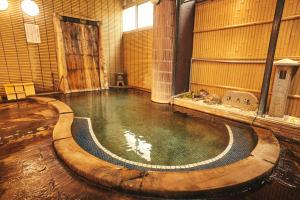 a large pool of water in a large room with at Nogami Honkan in Beppu