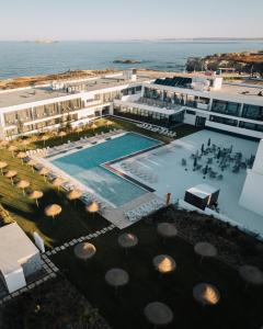 an aerial view of a resort with a swimming pool at Porto Covo Praia Hotel & SPA in Porto Covo