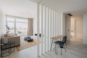 a living room with a couch and a table at Porto Covo Praia Hotel & SPA in Porto Covo