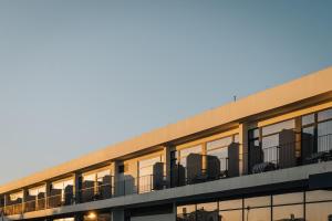 an office building with a lot of windows at Porto Covo Praia Hotel & SPA in Porto Covo