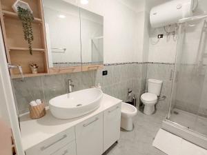 a bathroom with a sink and a toilet and a shower at Boho style in Center of Tirana in Tirana