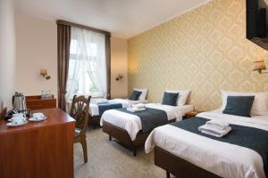 Posteľ alebo postele v izbe v ubytovaní Aparthotel Globus Kraków