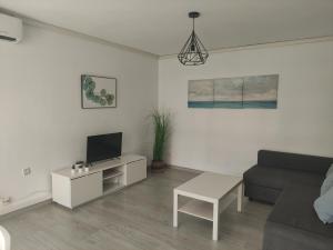 A television and/or entertainment centre at Albir cosy apartment