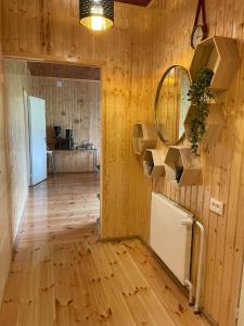 a room with a wooden wall with a refrigerator in it at East side in Tervola with sauna and free parking in Tervola