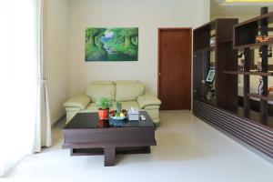 a living room with a couch and a coffee table at Royal Majesty Villas Jimbaran in Jimbaran