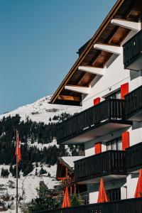 a building with balconies and a snow covered mountain at Experimental Chalet in Verbier