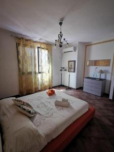 a bedroom with a large white bed in a room at Azzurra’s House Pantelleria in Pantelleria