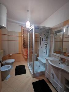 a bathroom with two sinks and a shower and a toilet at Azzurra’s House Pantelleria in Pantelleria