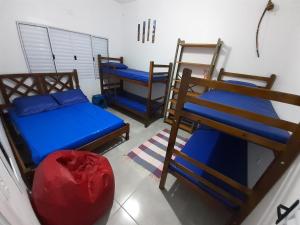 a room with three bunk beds in a room at A VER O MAR FLATS in Caraguatatuba