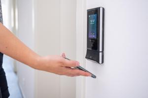 a person is unlocking a door with a pen at Suites Lohne, 24h Self Check In in Lohne
