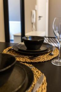 a table with black plates and a bowl and a glass at Veyron Apartments - part of the V Group in Blackpool