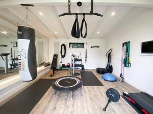 a room with a gym with a punching bag and weights at Little Owl A beautiful bolt-hole for couples in Aldeburgh